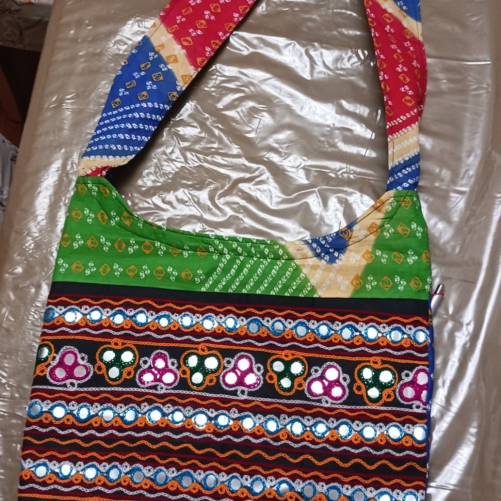 Brand new handbag. Ethnic. Embroidered. shoulder strap. Zipper closing.